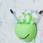 Toothbrush and toothpaste holder, frog head, green color